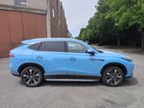 a blue suv parked in a parking lot next to a building