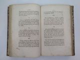 an open book on a table with a white background
