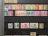 an image of a collection of stamps on display in a glass case