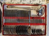 silverware in a box with red handles and spoons in it