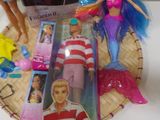 three barbie dolls sitting on a table next to each other