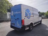 a blue and white van parked on the side of the road