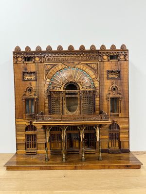 wooden model of a building with a clock on top of it