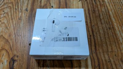 an image of a box of ear buds sitting on a wooden table