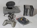 a lot of video games and a game controller on the table