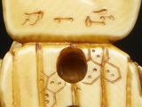 a close up of a ceramic figurine of a cat