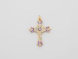 a gold cross pendant with blue and green enamel inlays