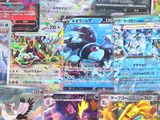 a lot of pokemon cards on display on a table