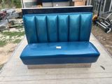 a blue bench that is sitting on the sidewalk