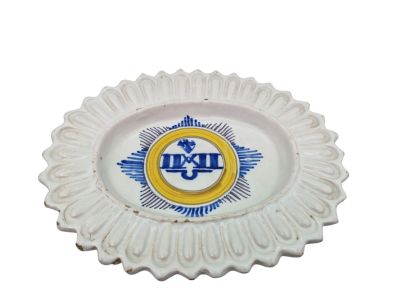 a white plate with a blue and yellow emblem on it