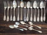a lot of silver spoons and spoon spoons on a table