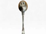 a silver spoon with a wooden handle on a white background