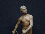 a statue of a man with a knife in his hand