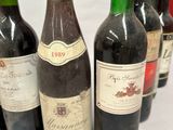 several bottles of wine are lined up on a table
