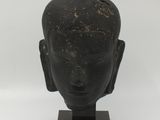 an image of a statue of a head on a wooden base