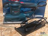 a corded sander sitting on top of a box