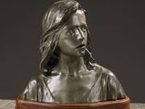 a bronze busturine of a woman smoking a cigarette