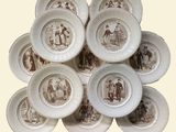a pile of plates with a picture of people on them