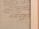 an old document with writing on it sitting on top of a wooden table