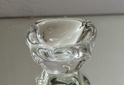 a clear glass candle holder on a glass table