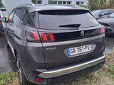 the rear end of a grey suv parked in a parking lot