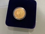 a gold coin in a velvet case on a table