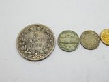 three different coins sitting next to each other on a white surface