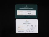 two business cards on a black table with a pen