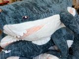 un grand requin en peluche posé sur un lit