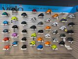 many helmets on display on the wall in the store