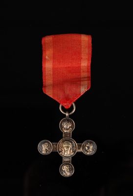 a close up of a red ribbon with a cross on it