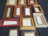 a lot of picture frames sitting on a table