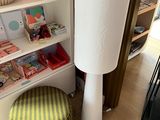 a lamp that is sitting on the floor next to a book shelf