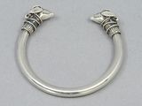 silver bracelet with two skulls on each side