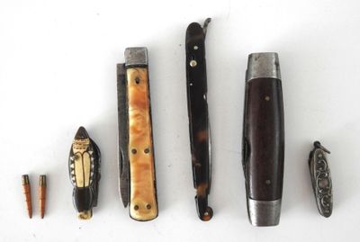 five different types of knives on a white surface