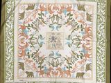 a green and white square with a floral design on it