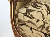 a brown and white couch with a floral pattern on it