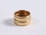 an image of a gold ring sitting on top of a white surface