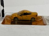 a yellow car that is sitting on a clear plate