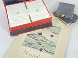 a book and a pair of earrings sitting on a table