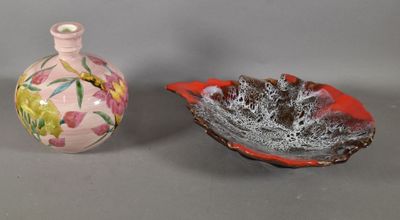 two small vases sitting next to each other on a table