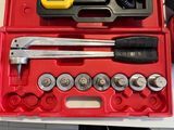 a red tool box with tools in it on a table