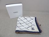 a white and blue blanket and a box on a bed