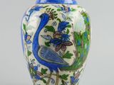 a blue and white vase with a bird on it