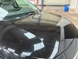 a black car that is parked in a parking lot