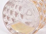 an image of a glass with a gold decoration on it