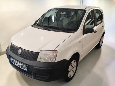 a small white car that is parked in a garage