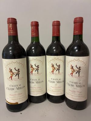 four bottles of red wine are lined up on a table