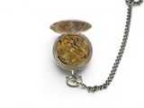 a silver pocket watch with a chain on a white surface