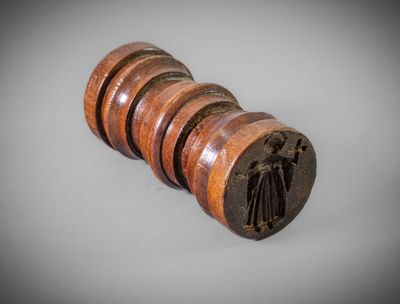 a close up of a wooden object on a white surface